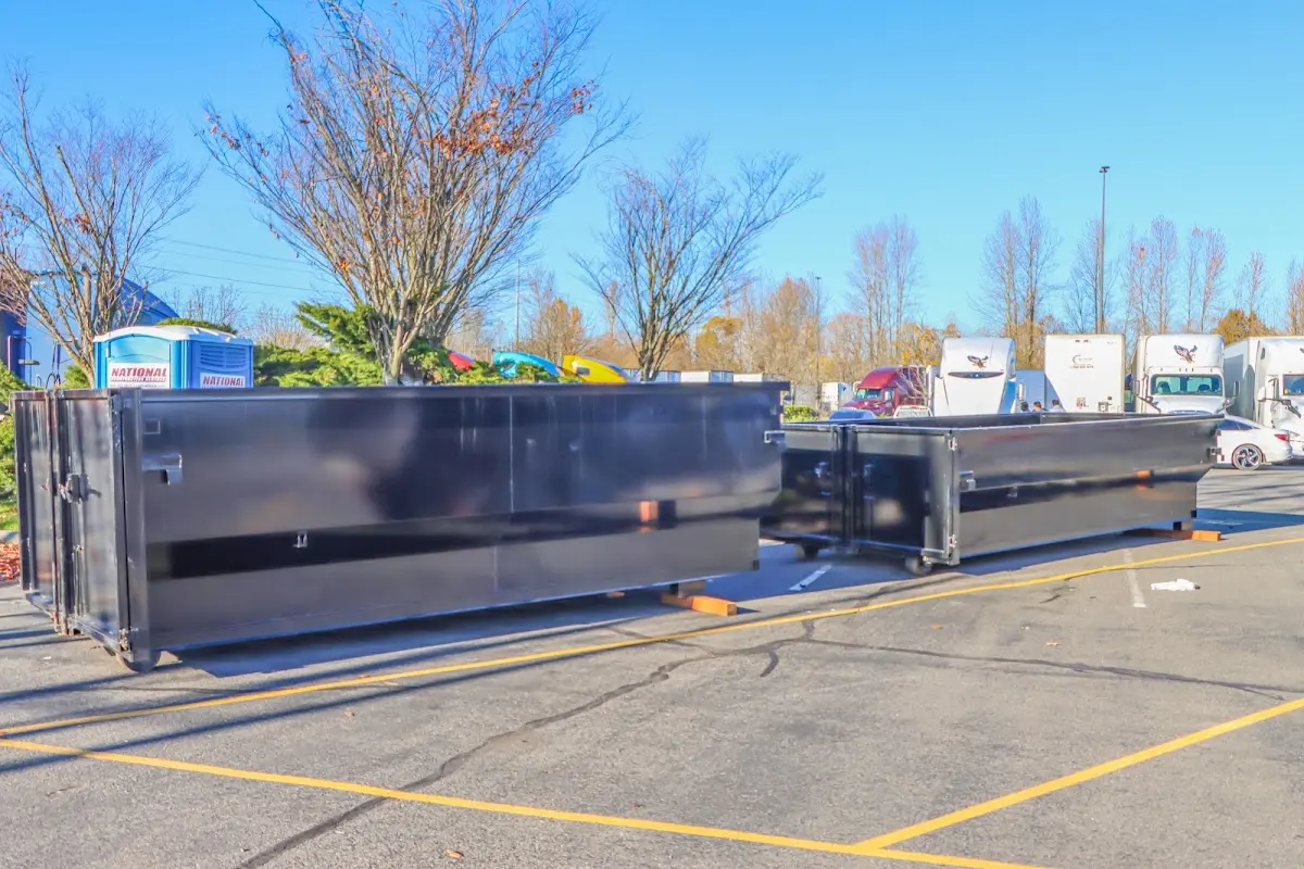 Professional dumpster rental service with roll-off container on residential driveway in Clovis